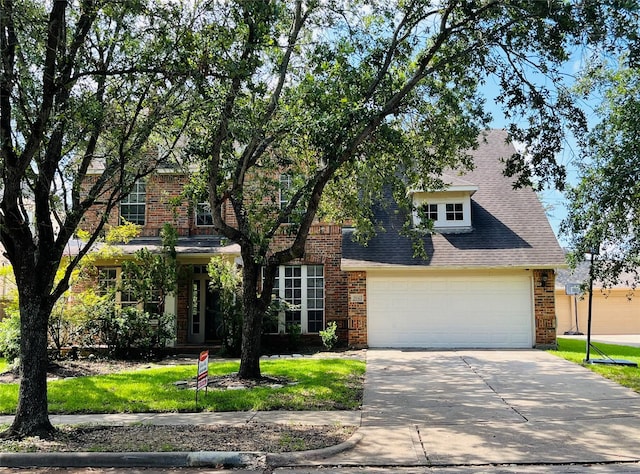 view of front of property with a garage and a front lawn