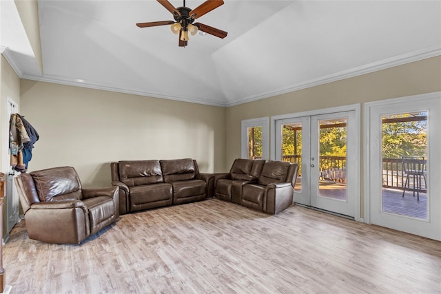 living room with light hardwood / wood-style floors, ceiling fan, french doors, vaulted ceiling, and ornamental molding