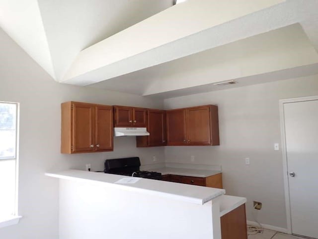 kitchen featuring lofted ceiling, black range, and kitchen peninsula