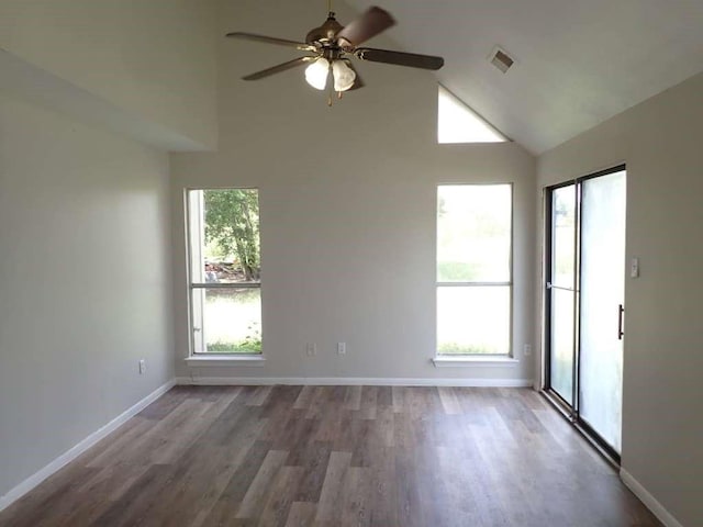 spare room featuring hardwood / wood-style flooring, ceiling fan, high vaulted ceiling, and a wealth of natural light