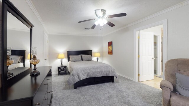 bedroom with ceiling fan, crown molding, carpet floors, and a textured ceiling