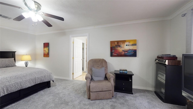 carpeted bedroom with ceiling fan and crown molding