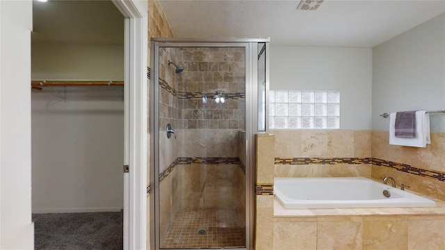 bathroom featuring independent shower and bath