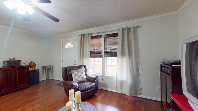 living area with dark hardwood / wood-style floors, ceiling fan, crown molding, and a textured ceiling