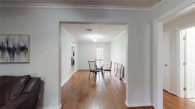 hall featuring wood-type flooring and ornamental molding