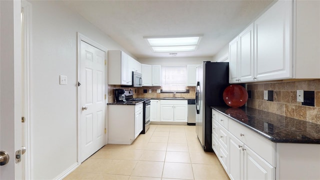 kitchen featuring light tile patterned flooring, sink, white cabinets, and stainless steel appliances