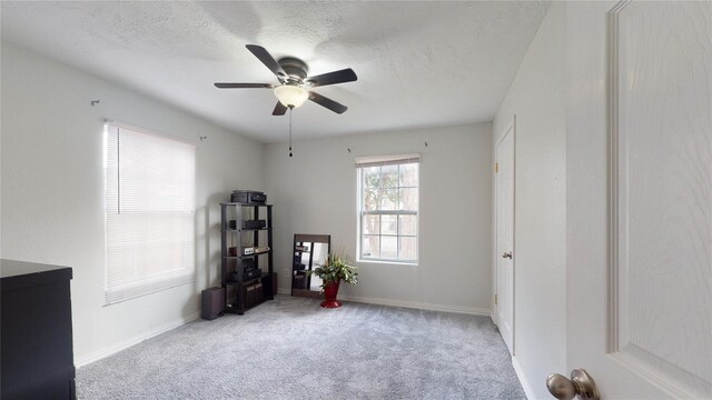 misc room with light carpet, a textured ceiling, and ceiling fan