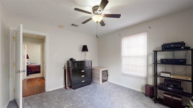 misc room featuring ceiling fan and light colored carpet