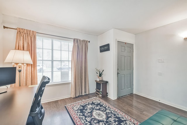 home office with dark hardwood / wood-style floors and a healthy amount of sunlight