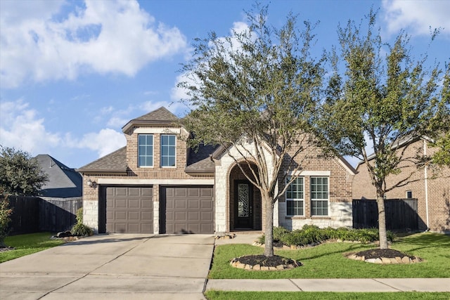 view of front of house with a front yard and a garage