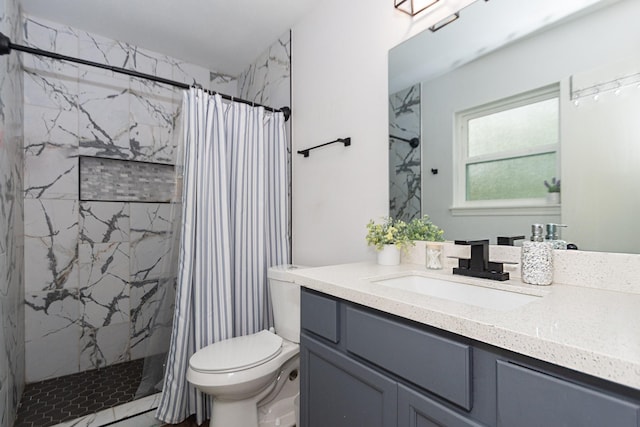 bathroom with a shower with curtain, vanity, and toilet