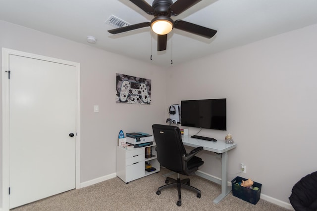 carpeted office space with ceiling fan