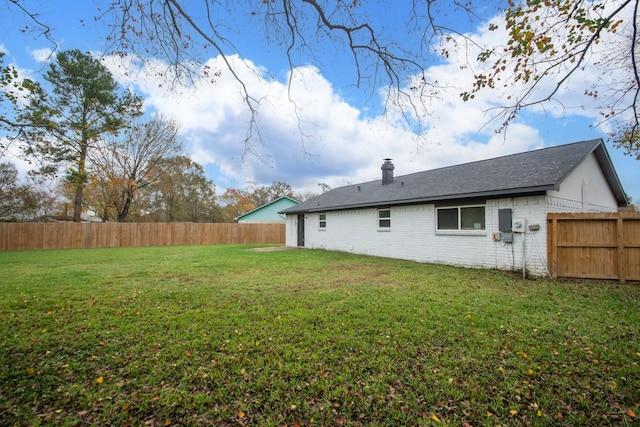 back of house featuring a yard