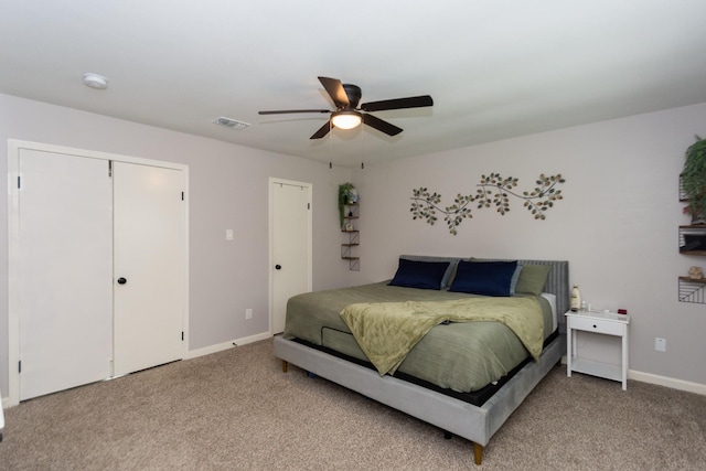 carpeted bedroom featuring a closet and ceiling fan