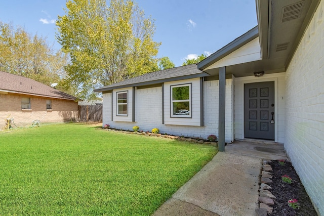 property entrance with a lawn