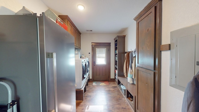 kitchen with washer and clothes dryer, stainless steel fridge with ice dispenser, dark wood-type flooring, and electric panel