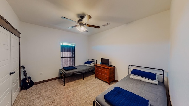 bedroom with light colored carpet and ceiling fan