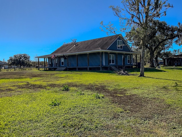 back of house with a lawn and a porch