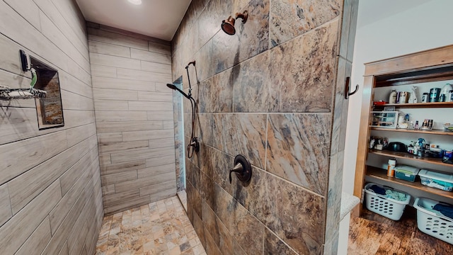 bathroom featuring tiled shower and hardwood / wood-style floors