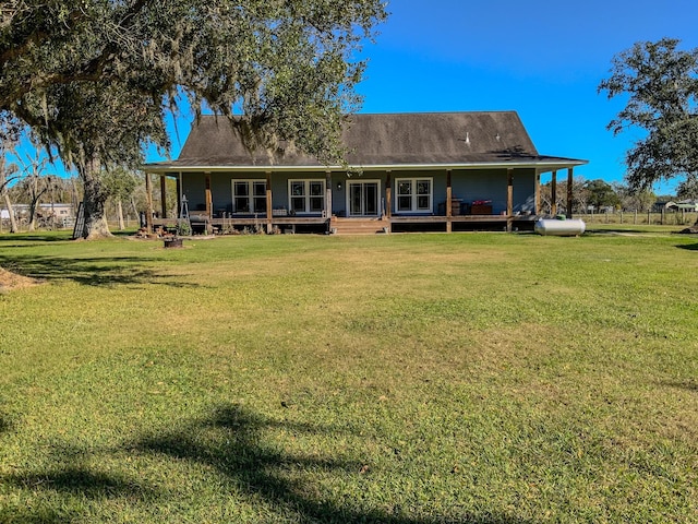 back of property with a lawn