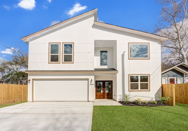 view of front facade featuring a front yard, a garage, and french doors