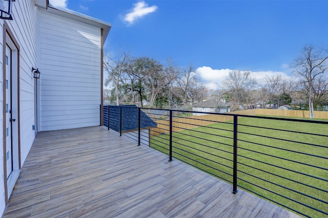 wooden deck with a lawn