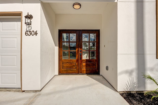 view of exterior entry featuring french doors