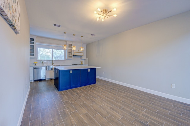 kitchen with decorative light fixtures, blue cabinets, a kitchen island, stainless steel dishwasher, and white cabinets