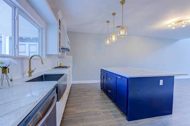 kitchen featuring white cabinets, stainless steel appliances, blue cabinetry, backsplash, and hanging light fixtures