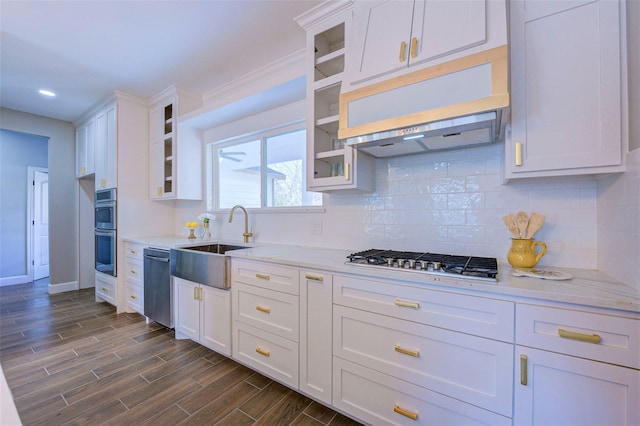 kitchen with appliances with stainless steel finishes, white cabinets, and sink