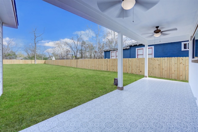 view of yard featuring ceiling fan and a patio area