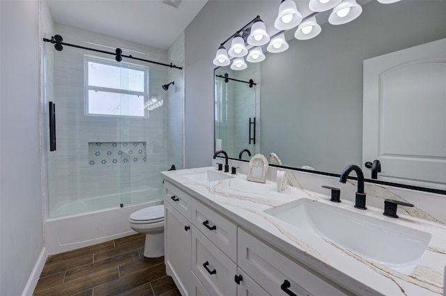 full bathroom with toilet, vanity, and shower / bath combination with glass door