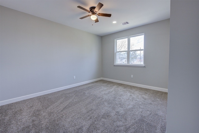 spare room featuring ceiling fan and carpet