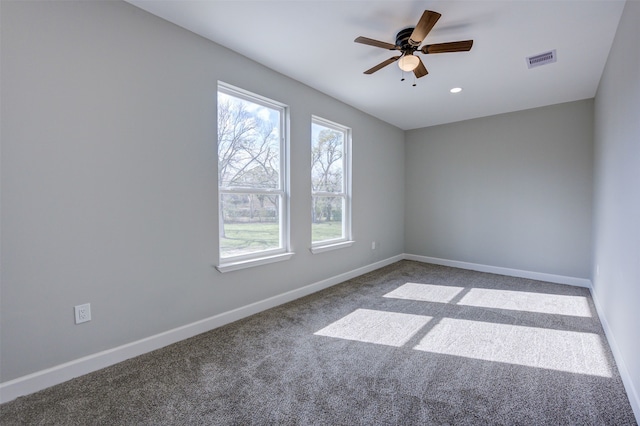 carpeted spare room featuring ceiling fan