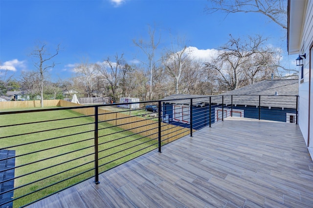 wooden deck featuring a yard