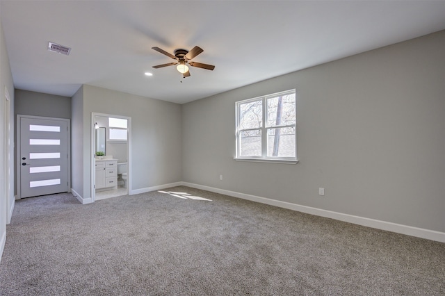 empty room with ceiling fan and light colored carpet