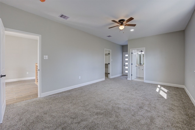 carpeted spare room with ceiling fan