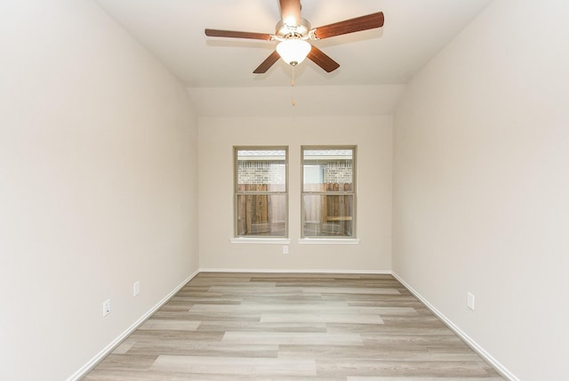 empty room featuring ceiling fan, light hardwood / wood-style flooring, and lofted ceiling