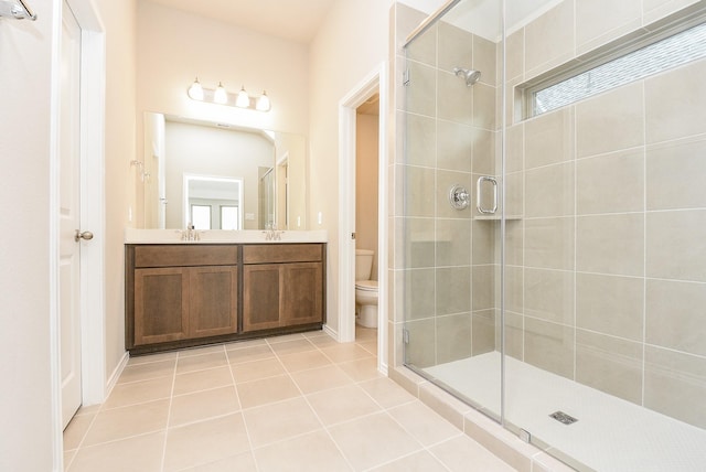 bathroom with walk in shower, tile patterned flooring, vanity, and toilet