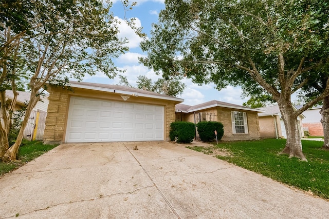 ranch-style house with a garage and a front lawn