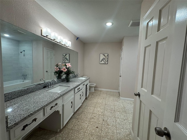 full bathroom featuring vanity, toilet, and tiled shower / bath combo