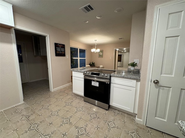 kitchen with kitchen peninsula, stainless steel electric stove, pendant lighting, a chandelier, and white cabinetry