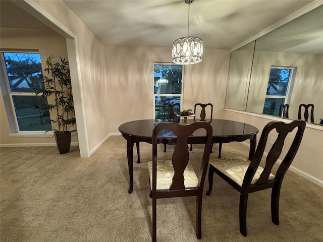 dining area featuring a chandelier and carpet