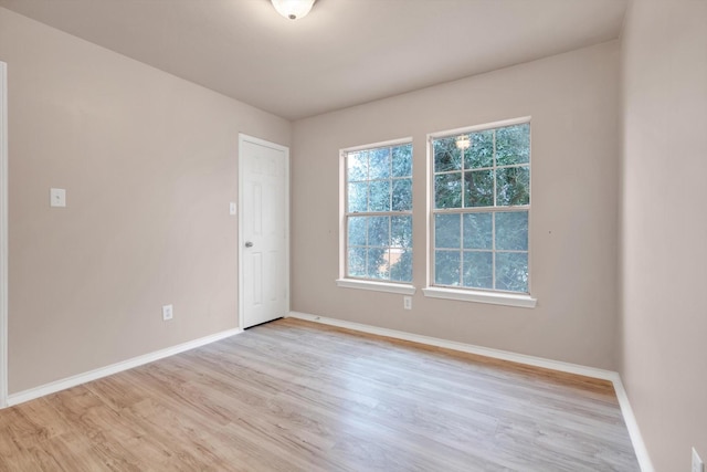 unfurnished room with light hardwood / wood-style floors