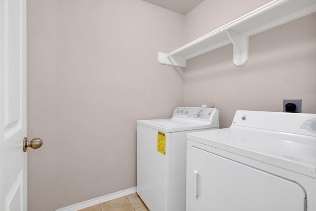 washroom with independent washer and dryer and light tile patterned floors