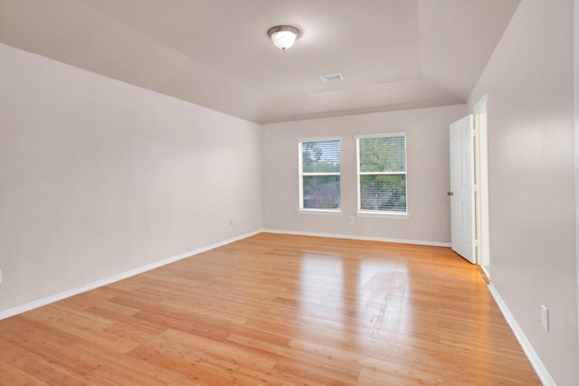 empty room featuring light hardwood / wood-style floors and lofted ceiling