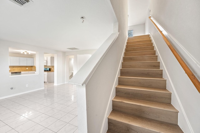 stairs with tile patterned flooring