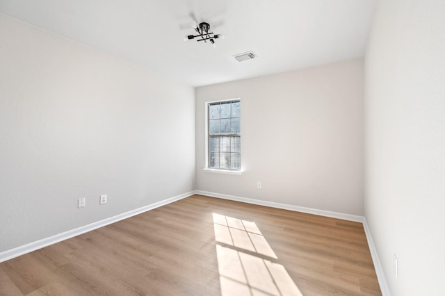 spare room featuring light wood-type flooring