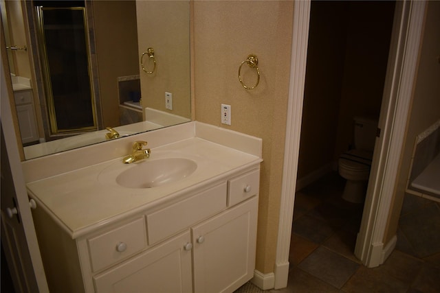 bathroom featuring tile patterned floors, vanity, and toilet