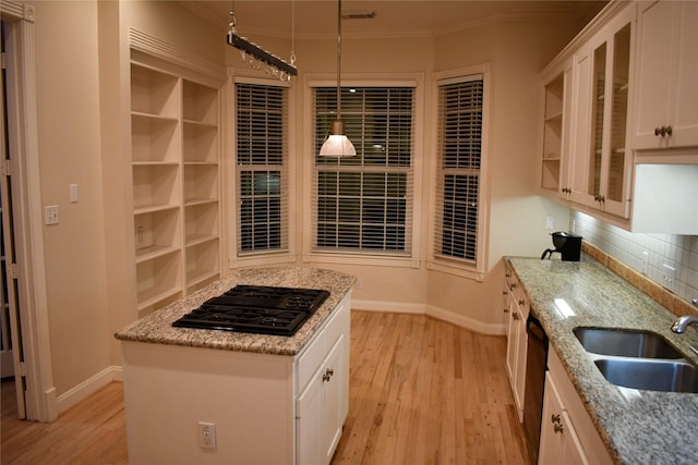 kitchen featuring white cabinets, black gas stovetop, sink, light hardwood / wood-style flooring, and tasteful backsplash